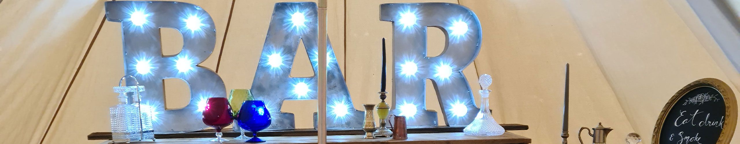 Festoon and fairy lighting strung across a barn venue