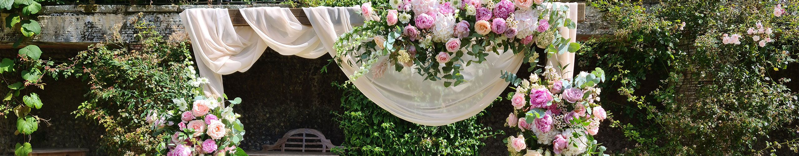 A floral arch dressed for a wedding ceremony